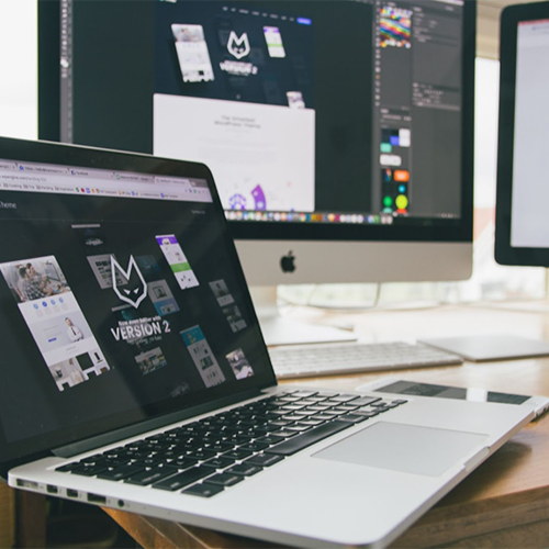 A Graphic Designer's workstation with computer and screens