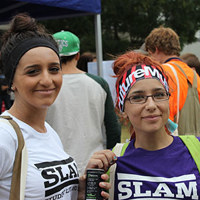 Two women wearing SLAM merchandise