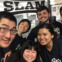 5 International Students with Melbourne Polytechnic t-shirts on, posing in front of the Slam room