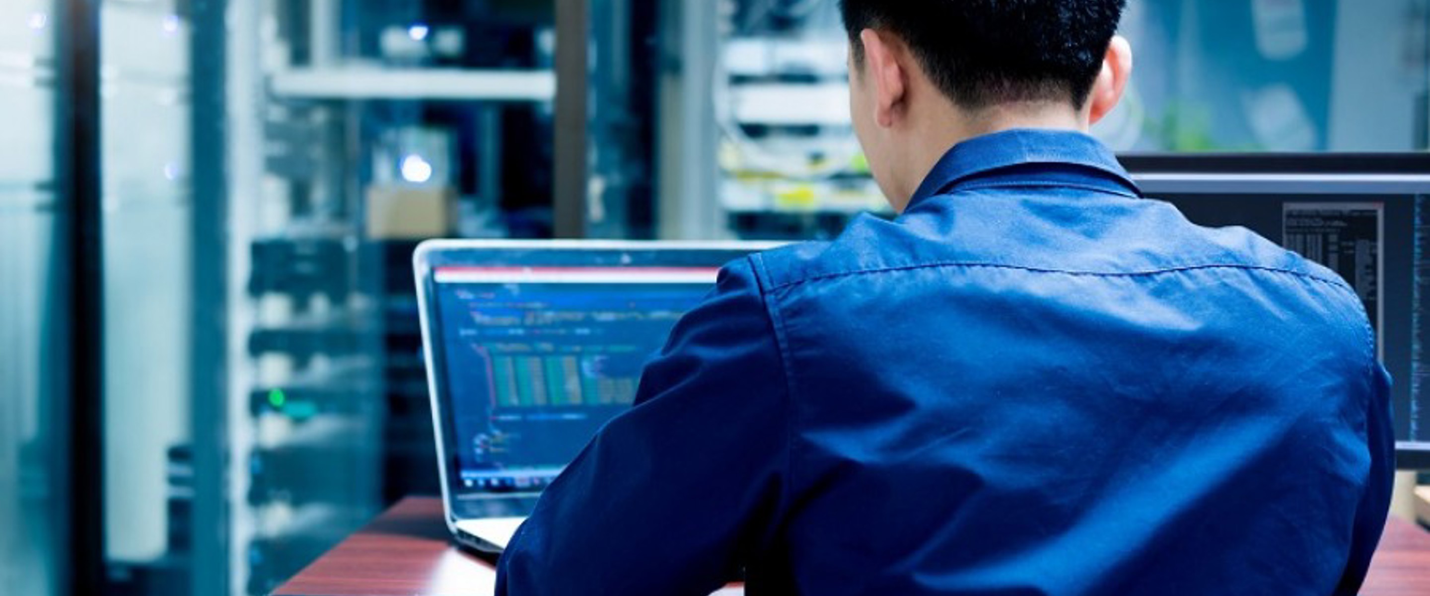 Man sitting at computer writing code