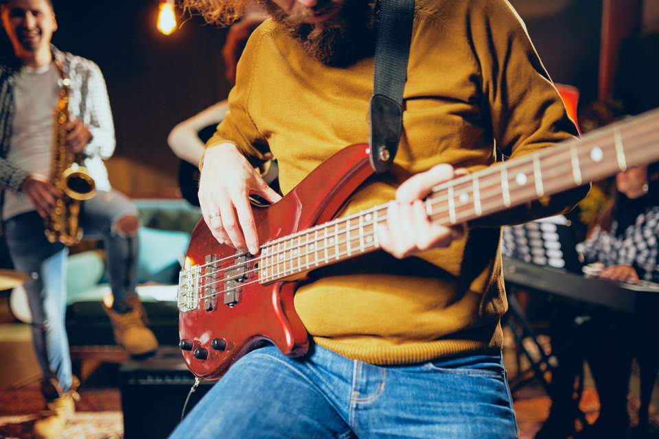 A person strumming an electric guitar