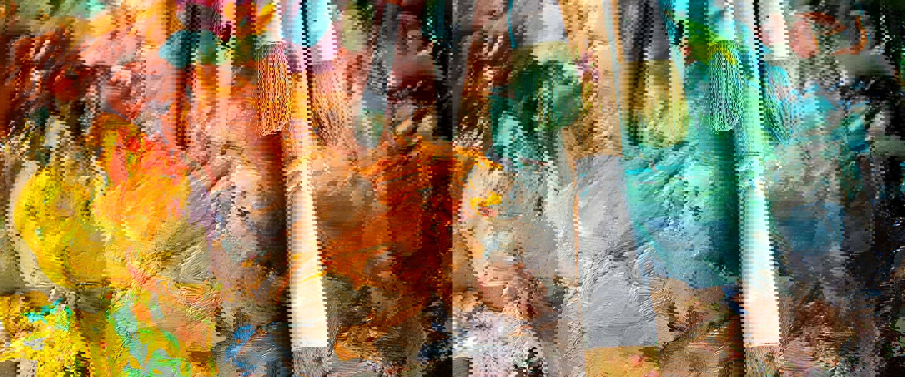 Different sized paint brushes lying on top of an abstract painting