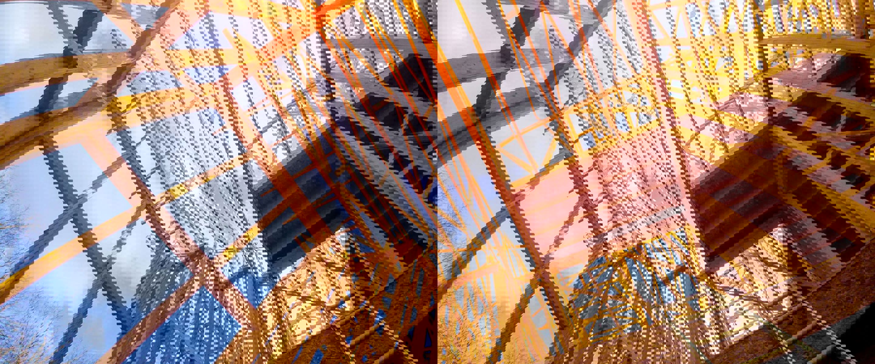 A worm's- eye view of the wooden frame of a house or building