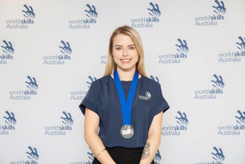 2018 student Leah Straughair with silver medal around neck at Worldskills Australia awards event