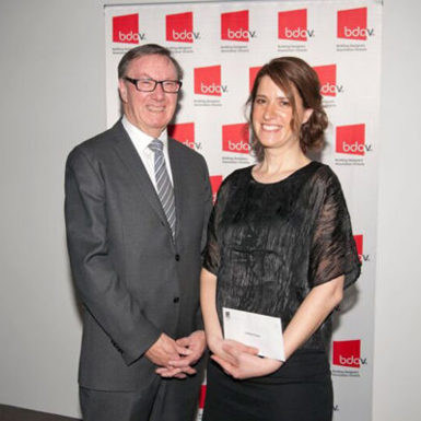 Lindsay Fischer smiling for camera with man in suit