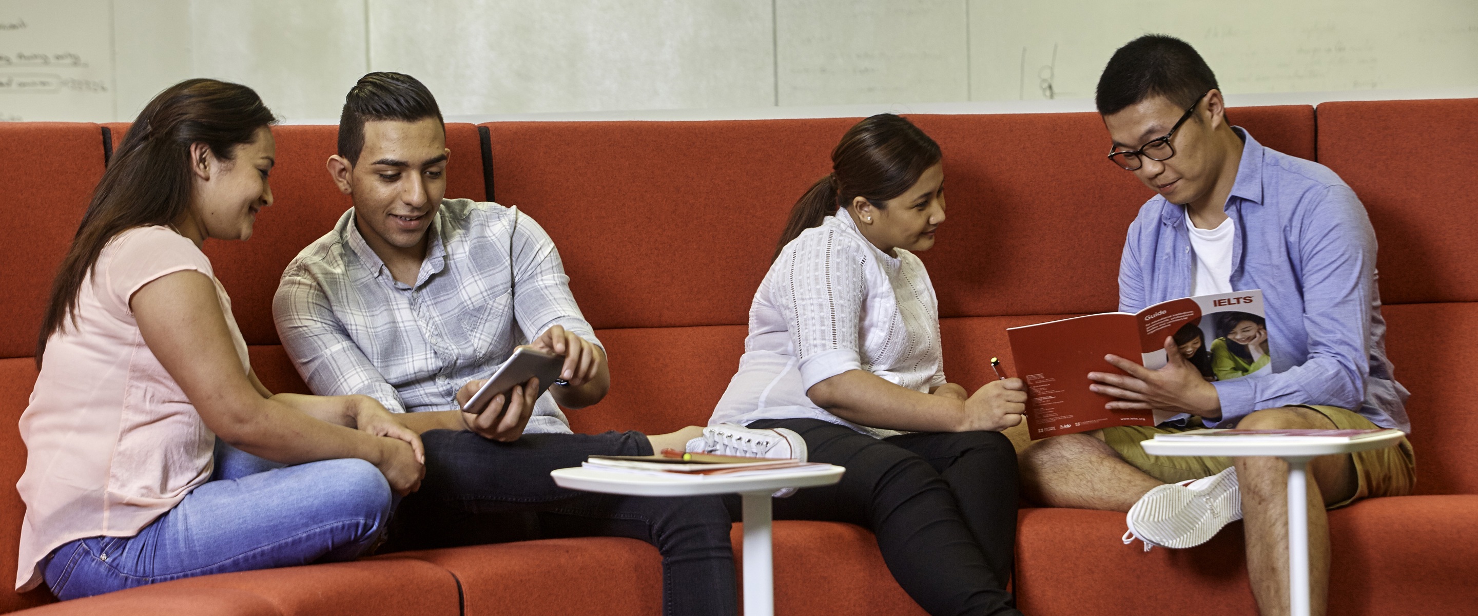 Four people discussing IELTS