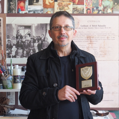 Con standing with his award