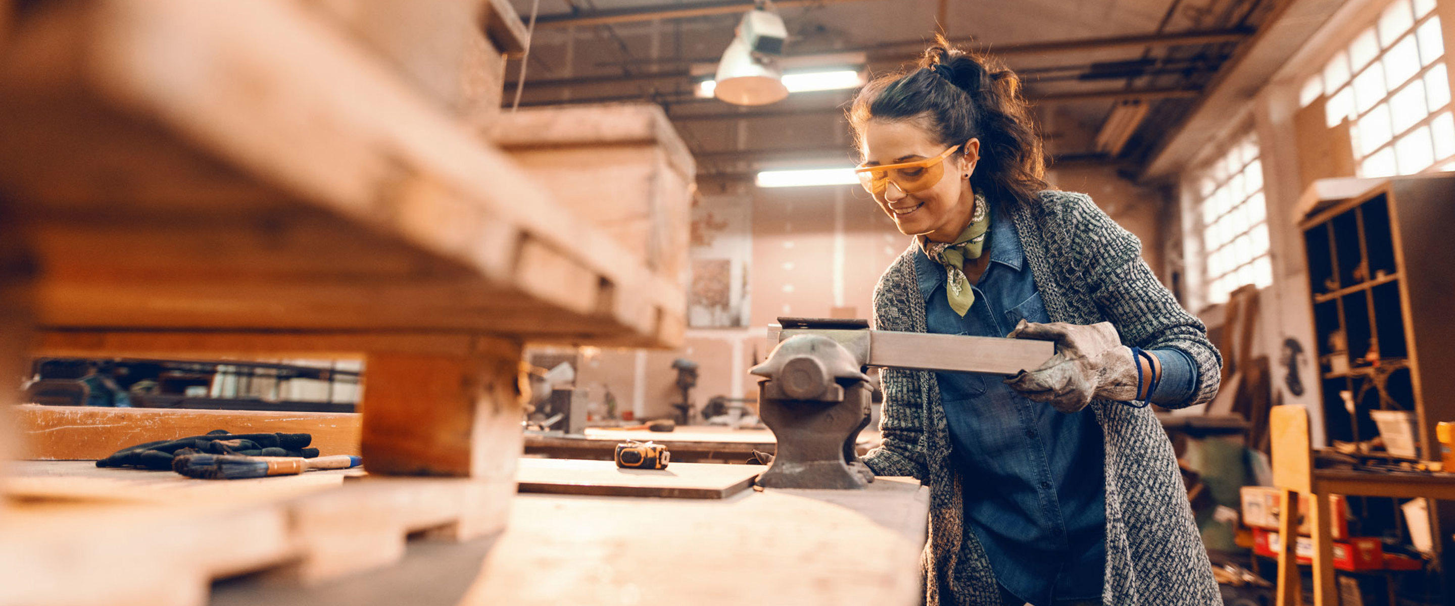 A person cutting wood in a vice