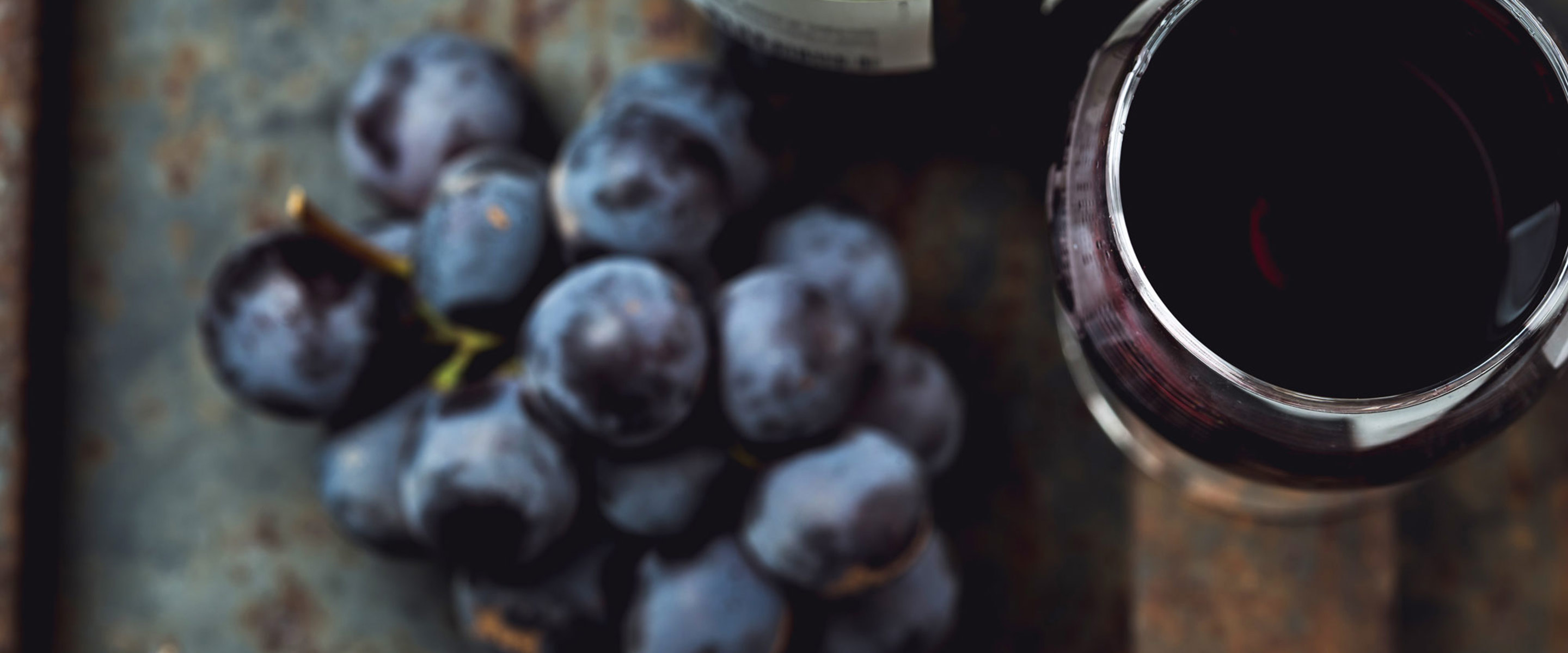 A small handful of blueberries next to two jars