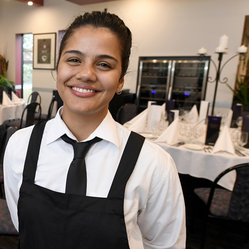 Portrait of Claudia wearing an apron and tie