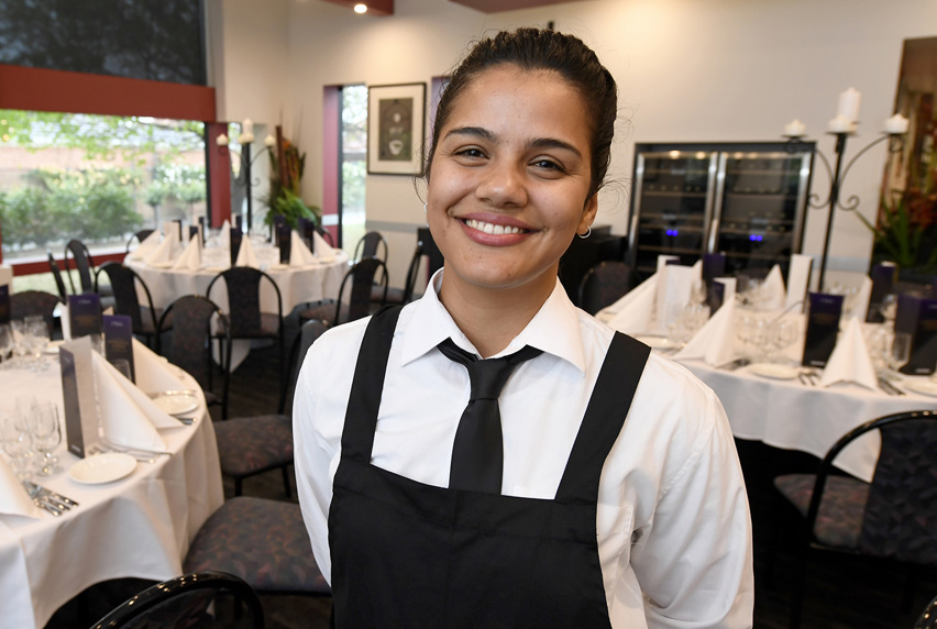 Portrait of Claudia wearing an apron and tie