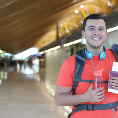 A traveling student holding his passport