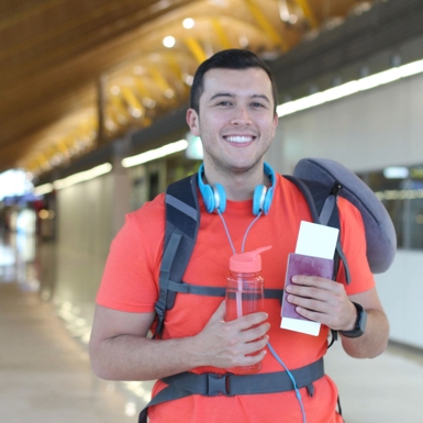 A traveling student holding his passport