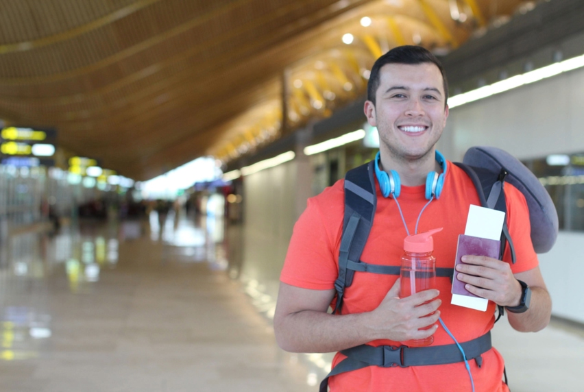 A traveling student holding his passport