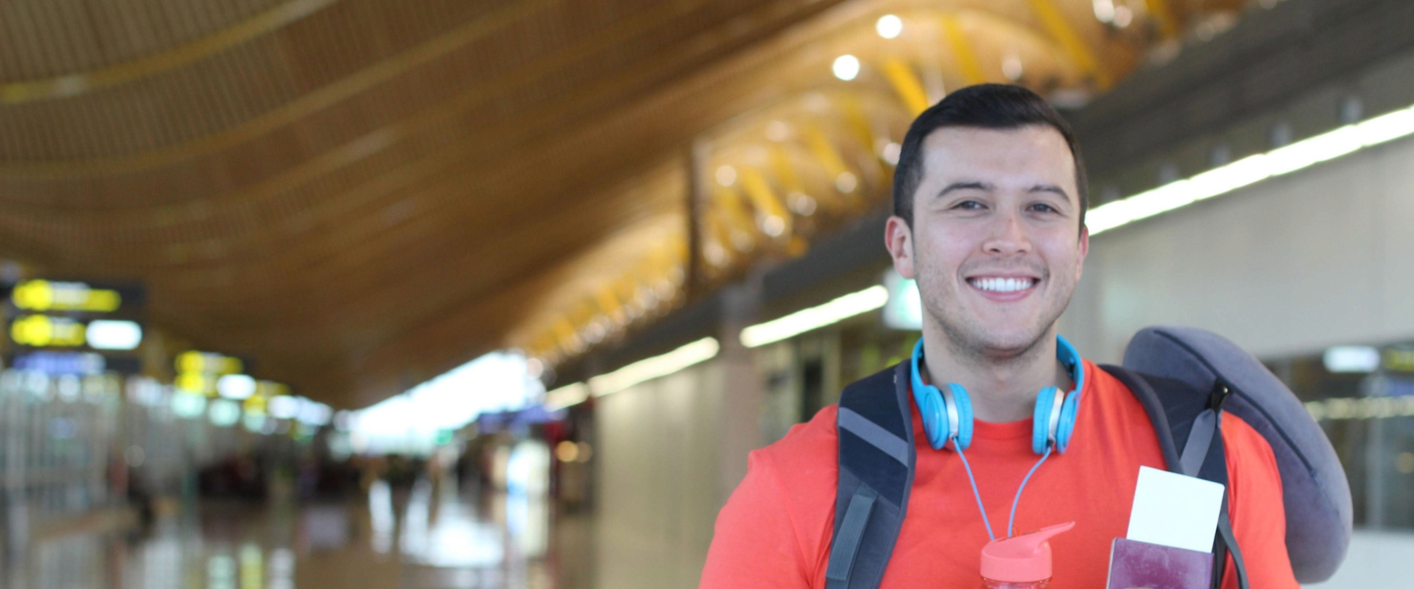 A traveling student holding his passport