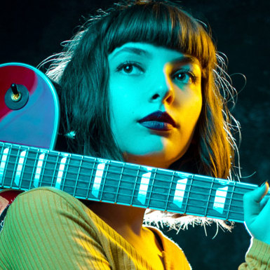 Musician with guitar over shoulder