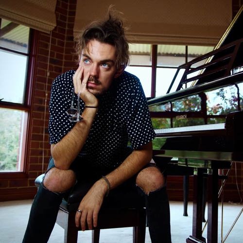 Portrait of musician sitting next to a piano