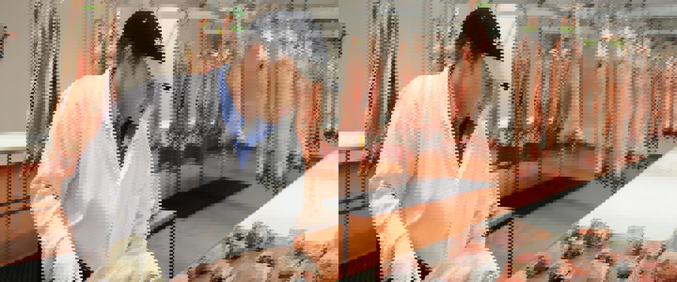 Man processing carcasses for meat products