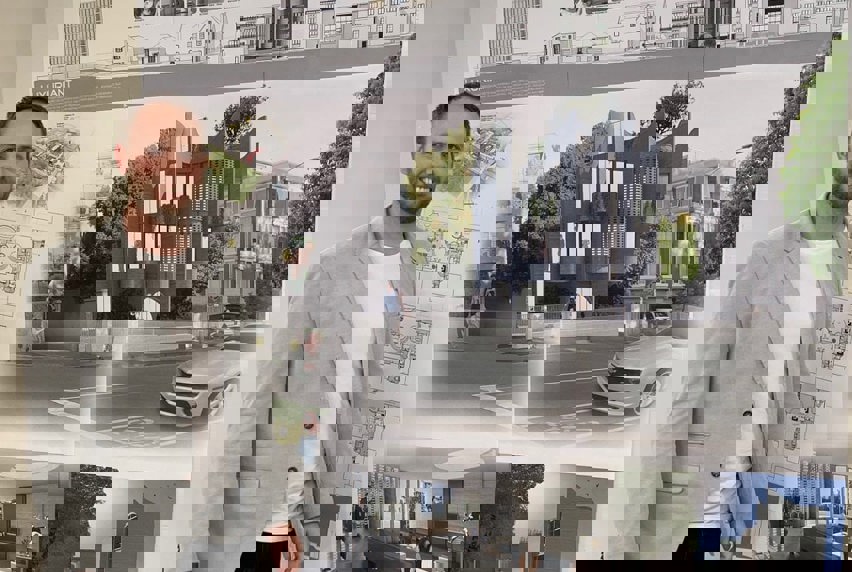 Building Design student standing in front of an architectural building design