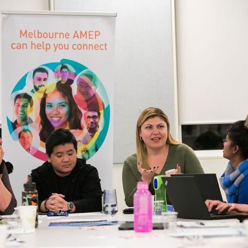 EAL, Adult Migrant English Program students sitting around table talking