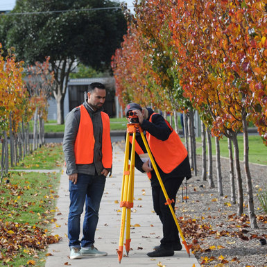 Building Surveying and Construction students with laser survey level tripod