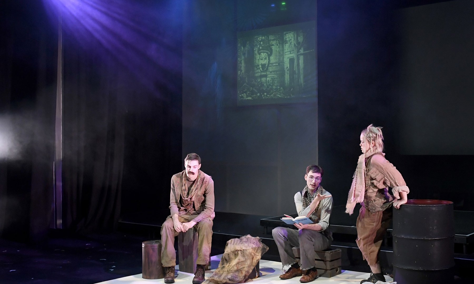 Students performing on stage in a play production