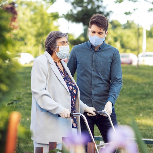 Elderly woman using walker