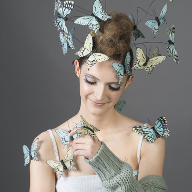 Hairdressing student covered in faux butterflies