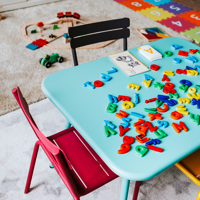 A blue children's table with educational toys in a childcare setting