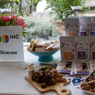 Packaged and baked food products on a table with brochures