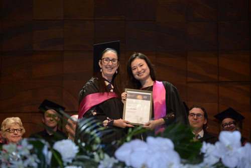 Ying Soon posing with testamur at graduation ceremony