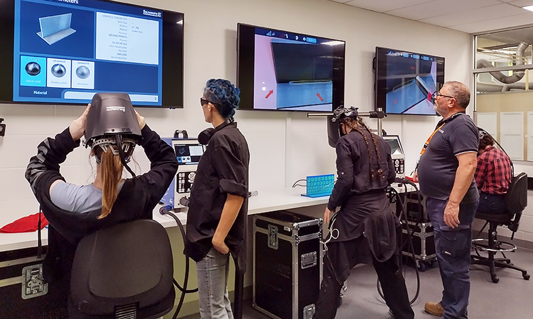 Female students practice on the Virtual Welders