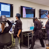Female students practice on the Virtual Welders