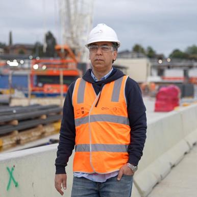 Reza, OQP student, wearing hi vis on a building site