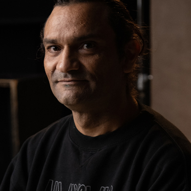 Rickie Martin wearing a black t-shirt while posing for a professional photograph.