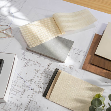 Assortment of fabrics and colours laying on top of building designs 