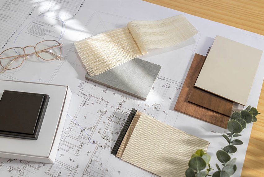 Assortment of fabrics and colours laying on top of building designs