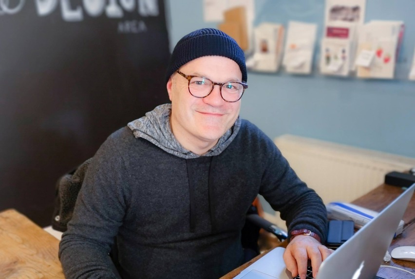 Image of Vincent Agostino, teacher at Melbourne Polytechnic, sitting in front of a laptop