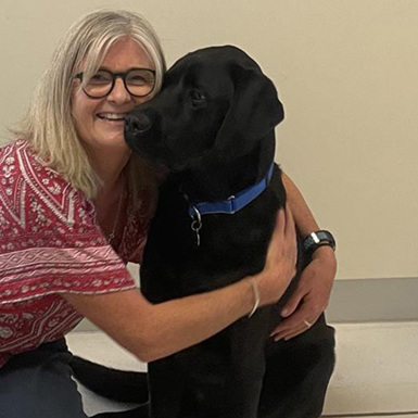 Kylie Smith hugging her dog, Ronan.