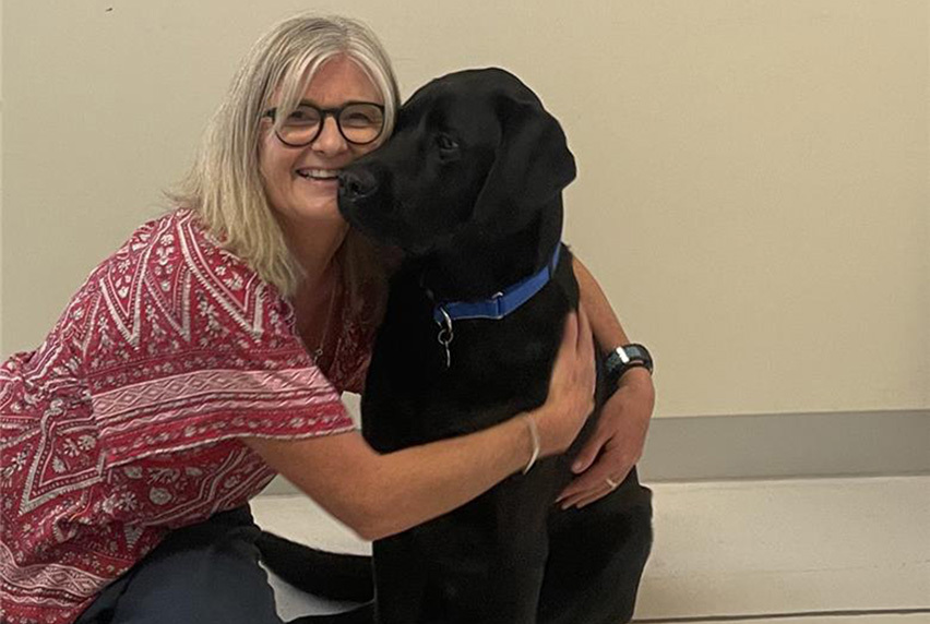 Kylie Smith hugging her dog, Ronan.