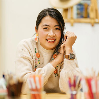 An image of a woman at a table with writing utensils, prepared for a productive day of teaching. 