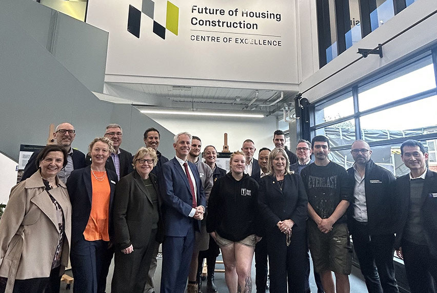 Staff and guests posing for a group photo at the inauguration of the Future of Housing Construction Centre of Excellence