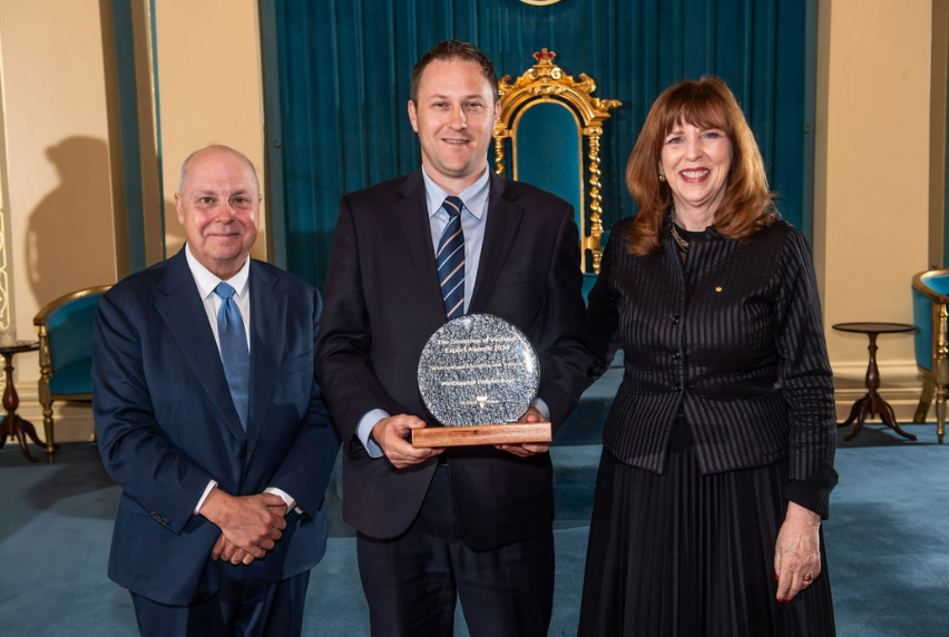 Tim Gilbert, Melbourne Polytechnic's Vice President International Development, holds the International Education and Training award standing beside Her Excellency Professor the Honourable Margaret Gardner AC Governor of Victoria and Minister for Economic Growth, Tim Pallas.