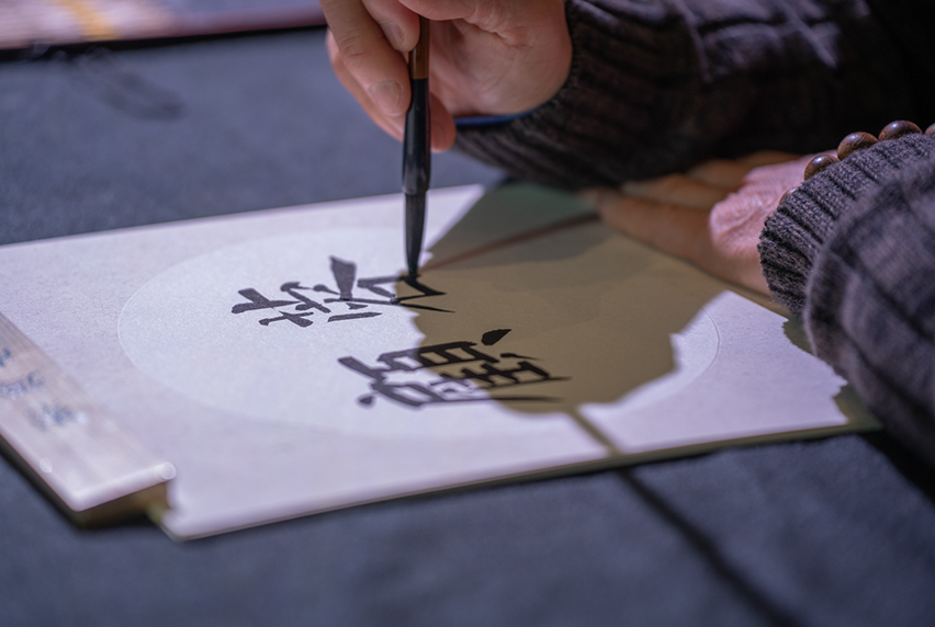 Close-up of person writing calligraphy