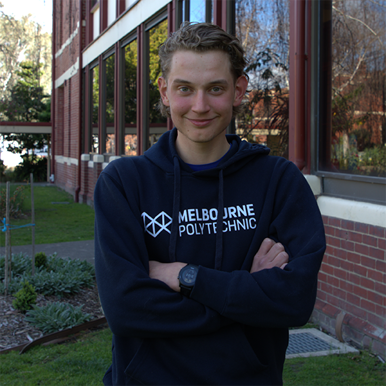 Harry Apostolopulos at the Fairfield campus wearing a Melbourne Polytechnic hoodie.