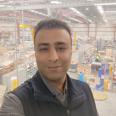 Headshot of Matt, OQP student, standing in a factory
