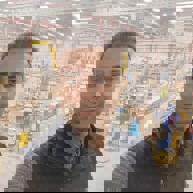 Headshot of Matt, OQP student, standing in a factory