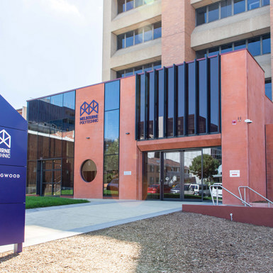 The Collingwood Campus entrance, displaying a blue sign that reads "Melbourne Polytechnic Collingwood."