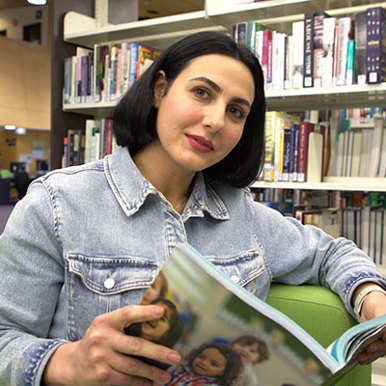 Headshot Mahnaz Mohammadi holding a book.