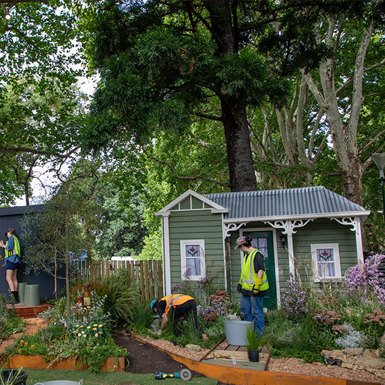 Students in high-visibility clothing constructing the “Throwing Shapes” and “Afterrain” gardens.